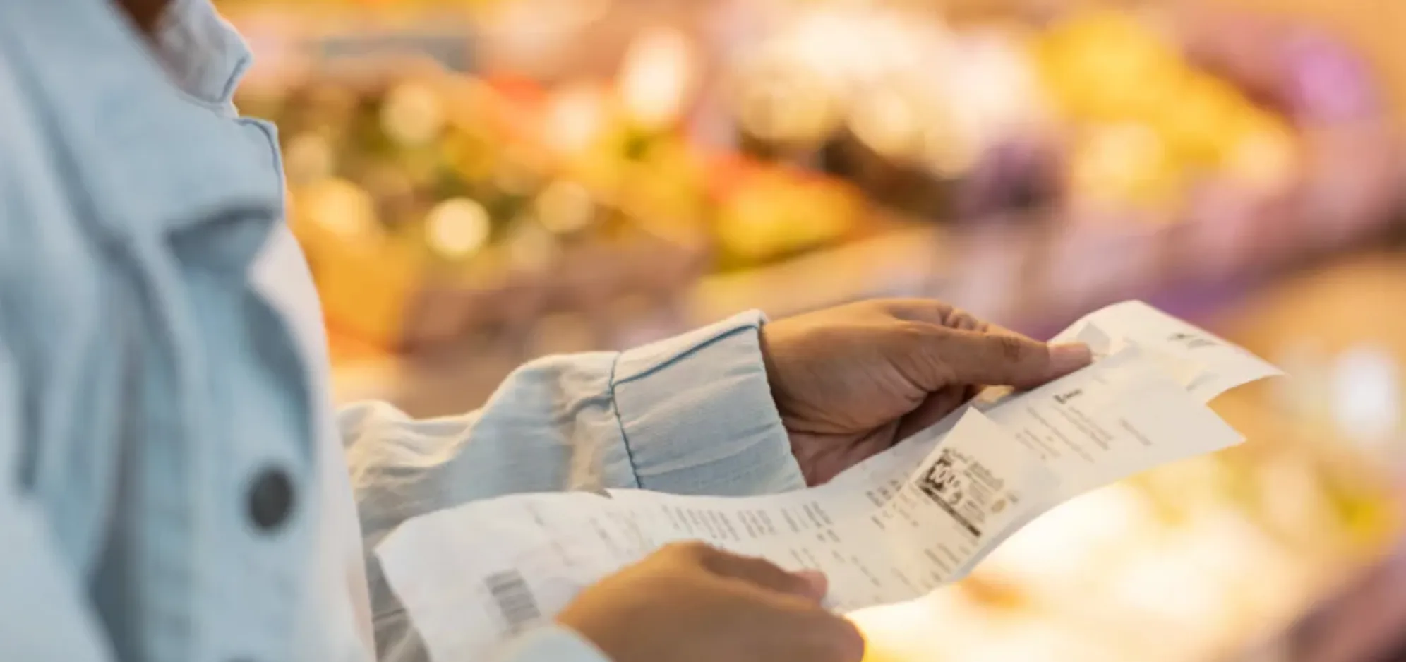 Hands holding a supermarket reciept